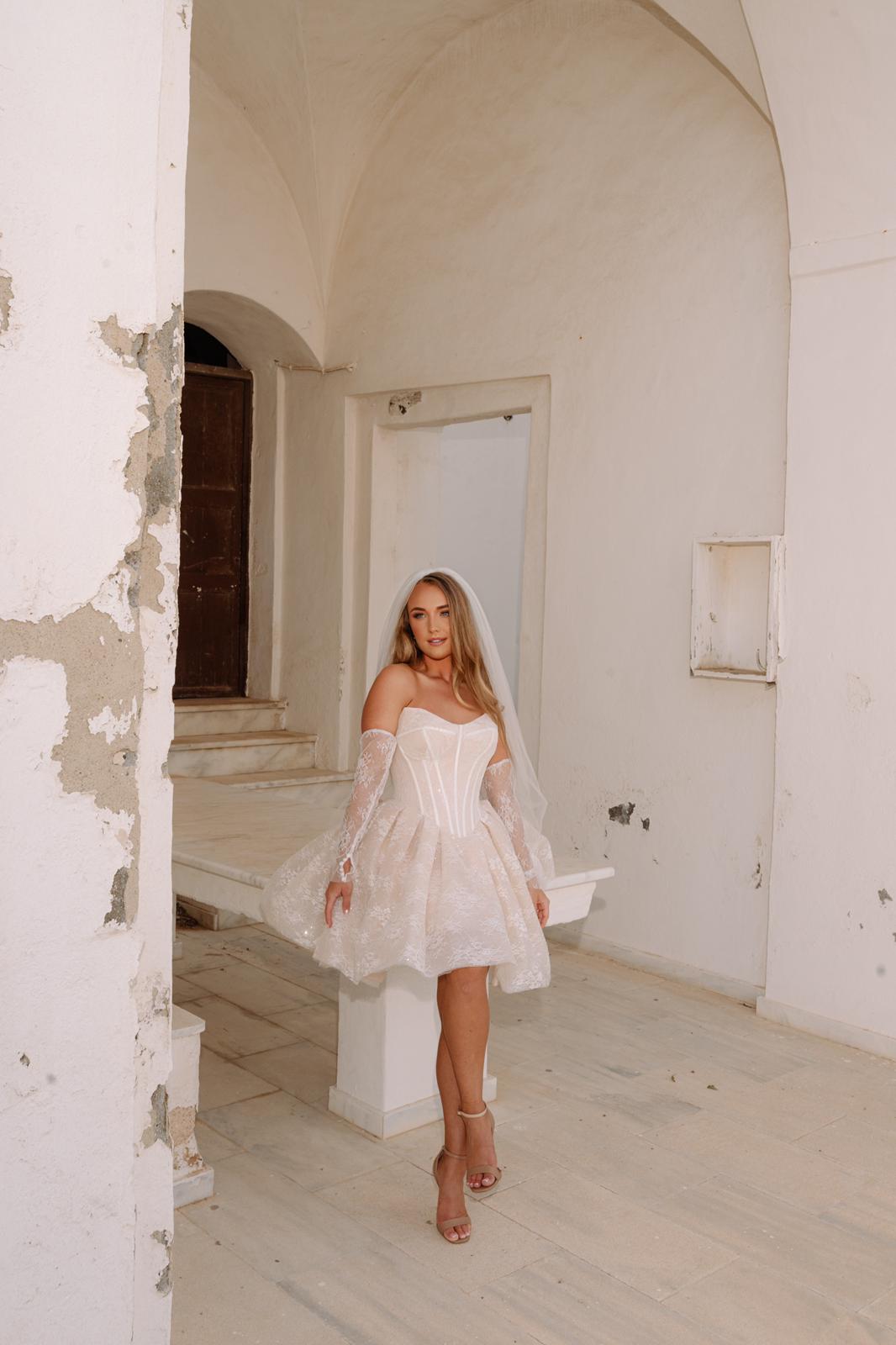 Model showcasing Clio Dress by Aurelle Attire, demonstrating its flattering fit and elegant design. Destination wedding Santorini