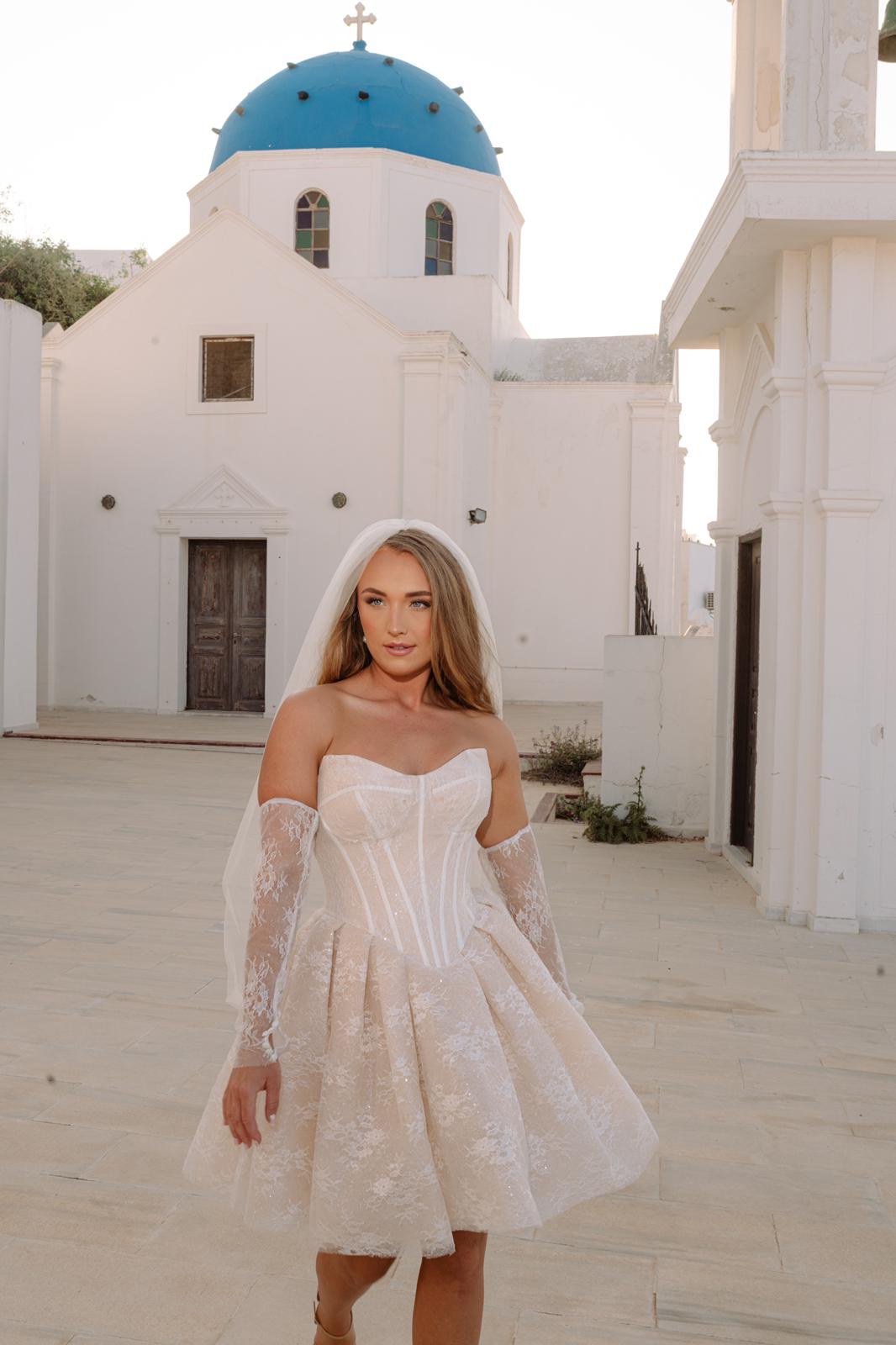 Bride wearing Clio Dress by Aurelle Attire in Santorini, highlighting the dress's suitability for destination weddings