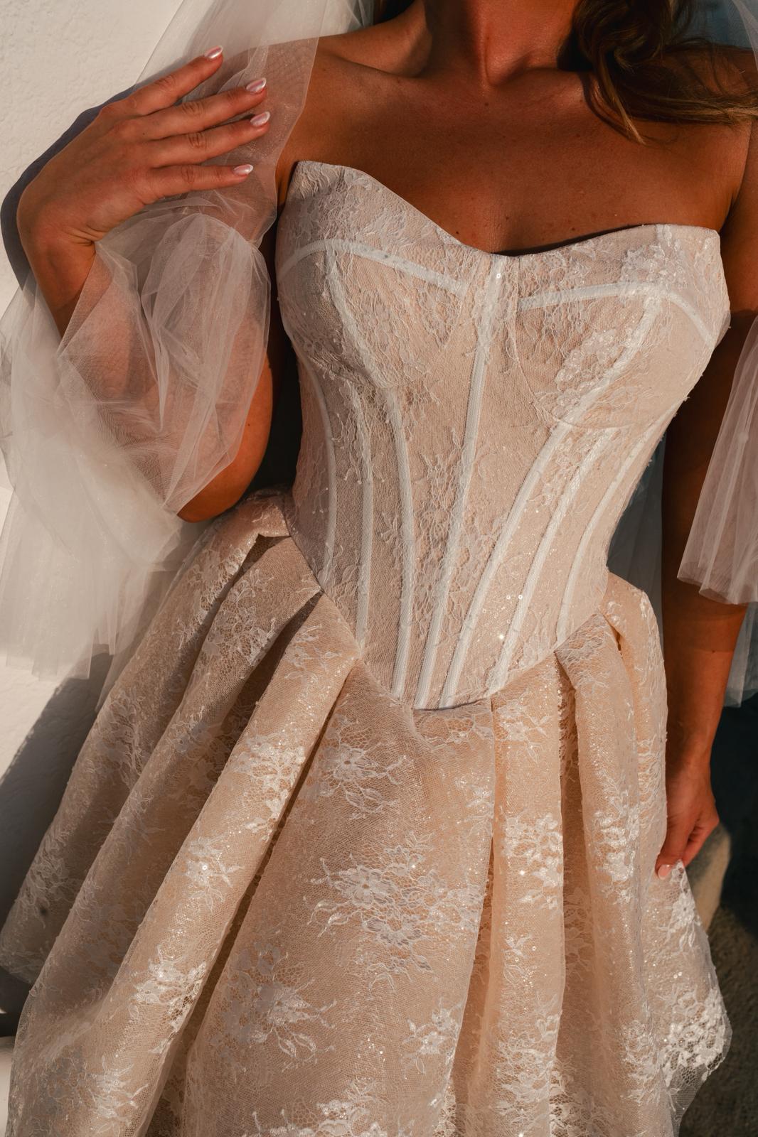 Close-up of Clio Dress fabric texture, emphasizing the luxurious blush tulle and shimmer lace material for short bridal dress