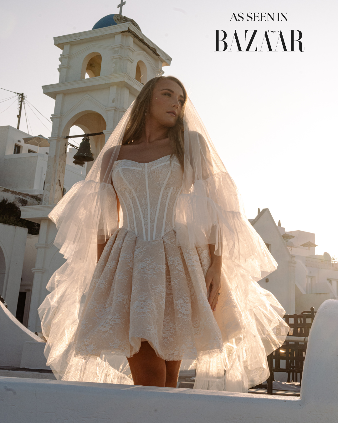 Clio Dress by Aurelle Attire – Blush mini bridal gown featuring a sculpted corset drop-waist bodice with sheer boning, detachable off-the-shoulder lace sleeves, and a layered tulle skirt with glitter lace overlay.
